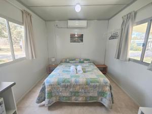 a bedroom with a bed with two pillows on it at Mt Barker Holiday Park - Western Australia in Mount Barker