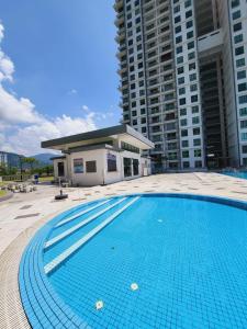 a large swimming pool in front of a building at Eijaz Homestay @ Casa Kayangan in Ipoh