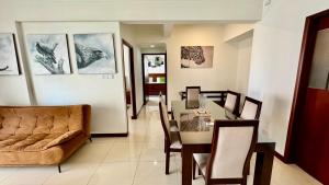 a dining room with a table and a couch at SkyLounge Apartment Colombo in Colombo