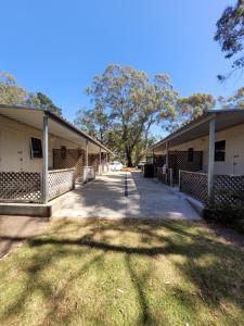 a row of buildings with a tree in the middle at Mt Barker Holiday Park - Western Australia in Mount Barker