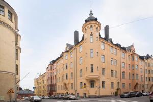 a large building with a clock tower on top of it at 2ndhomes Bright & Spacious 97m2 2BR Apartment w/Sauna in Katajanokka in Helsinki