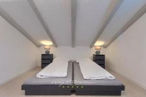 ein Schlafzimmer mit einem Bett und zwei Nachttischen in der Unterkunft Villa Pearl of Istria in Rovinjsko Selo