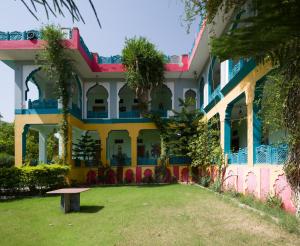 a building with a park in front of it at Hotel Prem Villas Pushkar in Pushkar