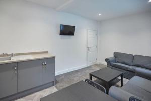 a living room with a couch and a tv at Zetland House Apt 4 in Loftus