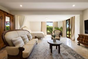 a living room with a couch and a bed at Riana in Coorabell Creek