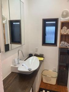 uma casa de banho com um lavatório e um espelho em Guest House Naze - Vacation STAY 14001 em Amami