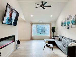 a living room with a couch and a flat screen tv at Trendy Trenholm in Elk Grove