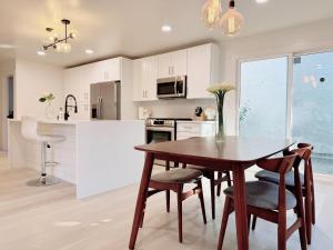 a kitchen with a wooden table and chairs in a kitchen at Trendy Trenholm in Elk Grove