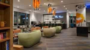 a restaurant with chairs and tables and a bar at Almond Hotel - Adults only in Neve Ilan