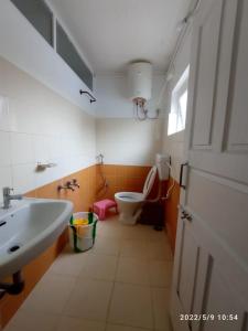 a bathroom with a sink and a toilet at Sun cool stay cottage in Kodaikānāl