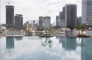 a pool with two trees in the middle of a city at Dua Sentral Residence near KL Sentral by COBNB in Kuala Lumpur
