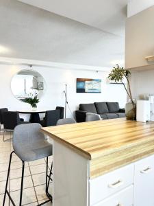 a kitchen and living room with a table and chairs at Core beachfront 2 Bedrooms Apartment by Gold Coast Premium in Gold Coast
