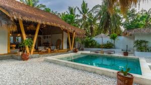 a villa with a swimming pool and a resort at Bundi's Villa in Gili Air