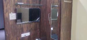 a wooden door with a window and a mirror at Jubilee Homes in Hyderabad