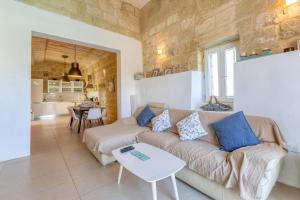 sala de estar con sofá y mesa en Ta'Patee Pool Farmhouse in Gozo - Happy Rentals, en Il-Wilġa