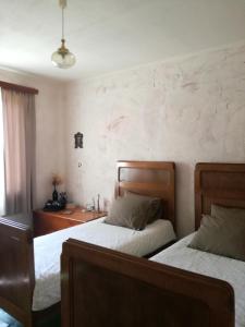 two beds in a room with a desk and a bed sidx sidx sidx at Bilkarskata Kashta in Gorsko Slivovo