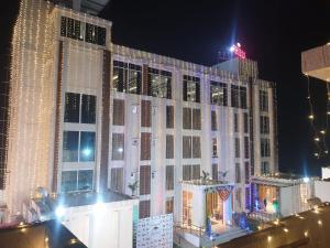 a large building covered in christmas lights at night at 7 Hills Hotel & Resort in Nalanda