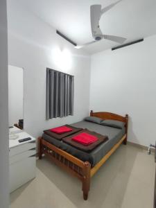 a bedroom with a bed and a ceiling fan at PEARL HUT home stay vythiri Wayanad in Vythiri