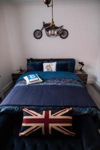 a bedroom with a bed with a motorcycle on the wall at Luxury ApArt Apartment Bedford Embankment & Free parking in Bedford