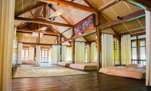 a large room with two beds and a sign at Bavi Hideaway Retreat - Venuestay in Ba Vì