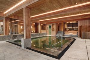 an external view of a house with a swimming pool at Gut Stiluppe - Good Life Hotel in Mayrhofen