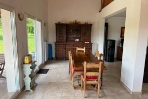 - une salle à manger avec une table et des chaises en bois dans l'établissement Maison Maizeray Saint Martin du Tartre, à Saint-Martin-du-Tartre