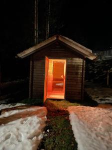 a small dog house with an orange door at night at Chalet Schäftal in Langau