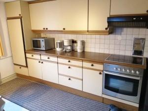 a kitchen with white cabinets and a stove top oven at Apartment Jerzens 1 in Jerzens