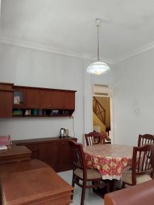 a dining room with a table and some chairs at Kluwih House in Godean