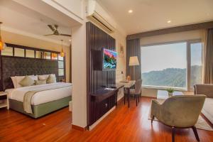 a bedroom with a bed and a desk and a chair at Amritara Surya - A Luxury Spa Retreat in Dharamshala +115 photos