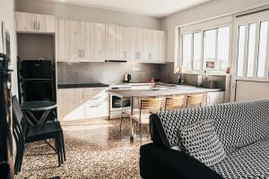 a kitchen with wooden cabinets and a counter top at Sparta Filoxenia House in Xirokámbion