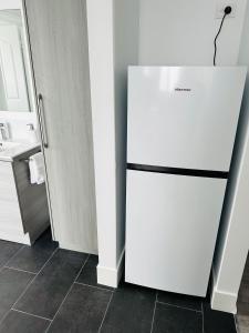 a white refrigerator in a kitchen next to a sink at Shellharbour Haven in Shellharbour