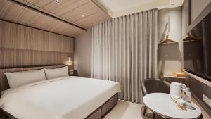 Katil atau katil-katil dalam bilik di Orange Hotel -Hanzhong, Taipei