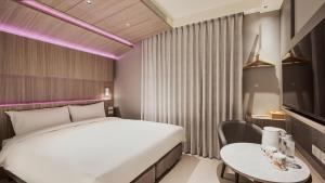 Katil atau katil-katil dalam bilik di Orange Hotel -Hanzhong, Taipei