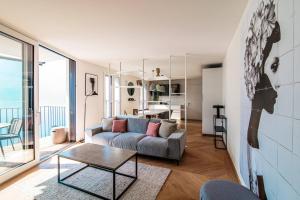 a living room with a couch and a table at Unique Gandria 3 by Quokka 360 - luxury two-bedroom apartment with a breathtaking view in Lugano