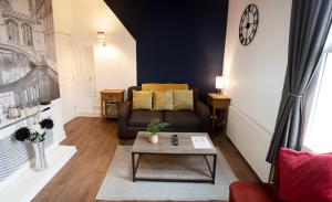 a living room with a couch and a table at Trinity, Central Cambridge Flat in Cambridge