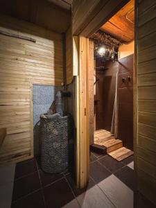 a bathroom with a walk in shower next to a toilet at River House in Nītaure