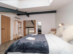 a bedroom with a large white bed in a room at Basswood Barn in Wincanton