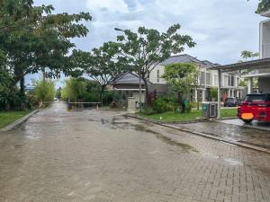 a flooded street in front of a house at Sweet House Homestay Near Mall Pekanbaru Sudirman in Pekanbaru