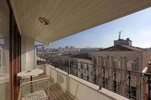 a balcony with a table and a view of a city at Mezzo Hotel in Istanbul