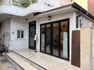 a building with glass doors on the side of it at Haru The Guesthouse in Andong