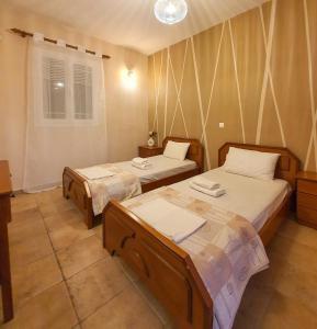 a room with two beds and a window at Villa Ioanna in Kalamitsi