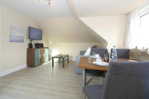 a living room with a couch and a table at Haus Sarah App 06 in Westerland