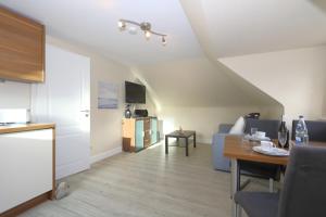 a living room with a couch and a table at Haus Sarah App 06 in Westerland