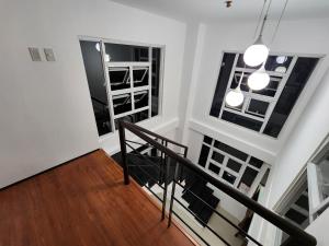 a staircase in a house with two windows at The Courtyards Goshen in Baguio