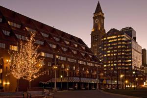 a large building with a clock tower and a christmas tree at Boston Marriott Long Wharf in Boston
