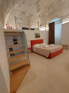 a bedroom with a bed and a staircase in a room at MandorleOlio in Polignano a Mare +37 photos