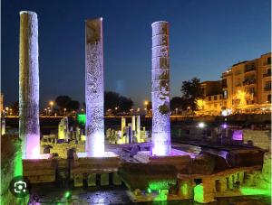 un groupe de piliers lumineux de nuit dans l'établissement House Serapide Puteoli, à Quarto