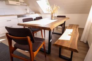 a kitchen with a wooden table and chairs at Naturzauber im Harz in Bad Lauterberg