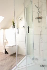 een badkamer met een glazen douche en een bad bij Naturzauber im Harz in Bad Lauterberg